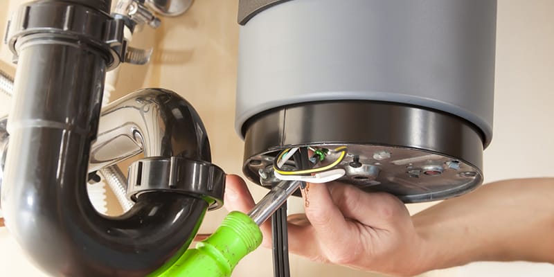 Mableton, Georgia plumber servicing water heater pipe connection