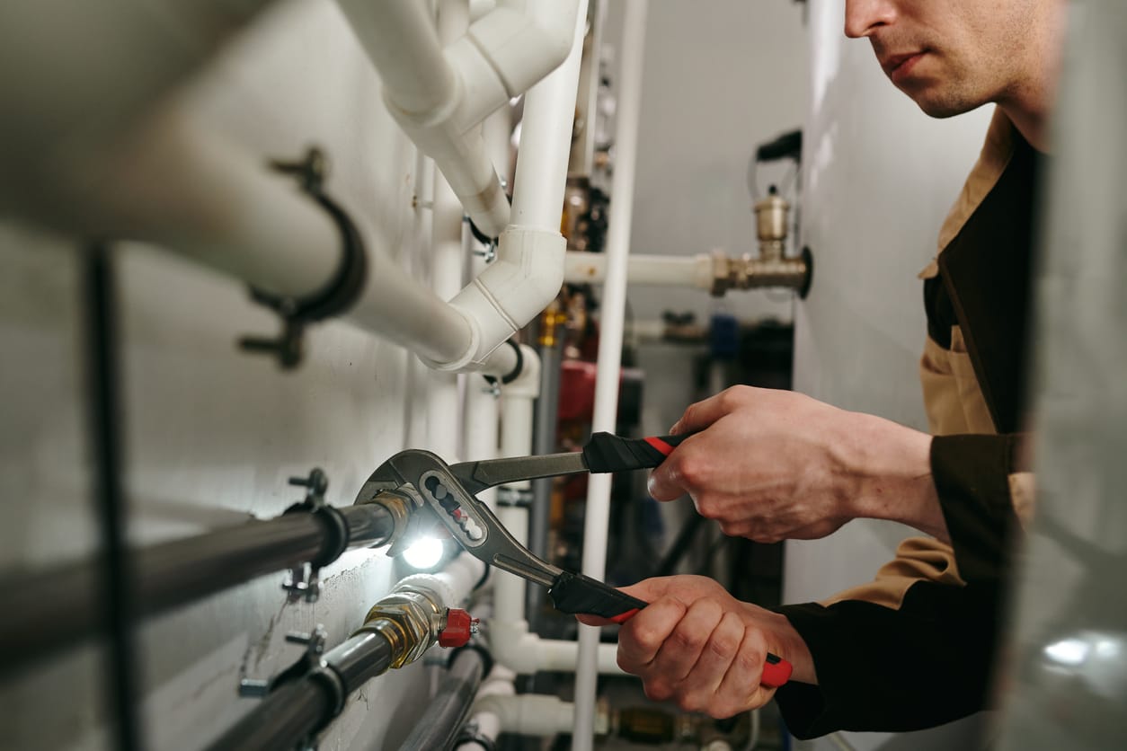 Plumbers maintaining commercial plumbing pipes in Mableton