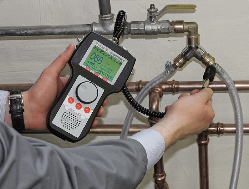 Plumber testing pipes with electronic leak detection equipment in Mableton